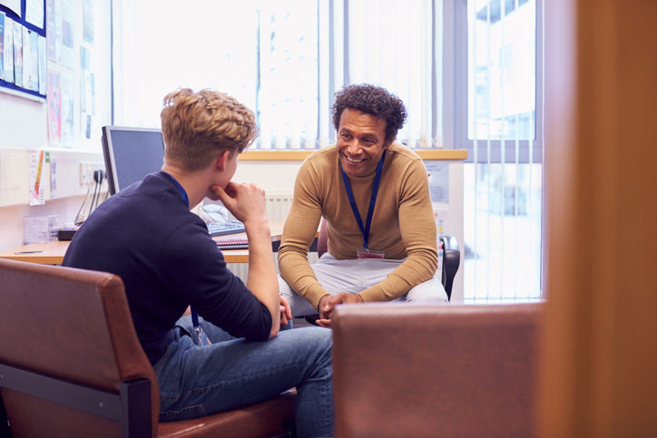 male social worker talking with student