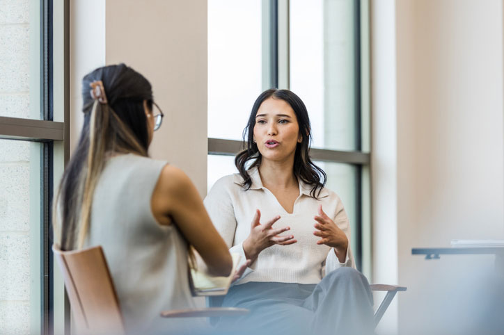 young adult female talking with social worker