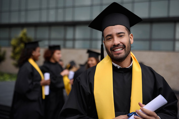 happy graduate in cap and gown